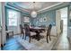 Elegant dining room with a crystal chandelier, dining table set for six, and beautiful wall decor at 5050 Watersail Way, Lake Wylie, SC 29710