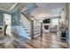 Inviting entryway with hardwood floors, staircase, and views of the living room with fireplace at 5050 Watersail Way, Lake Wylie, SC 29710