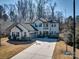 Charming two-story home featuring a spacious driveway, attached garage, and landscaped front yard on a sunny day at 5050 Watersail Way, Lake Wylie, SC 29710