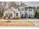 Charming two-story home with a covered porch, stone accents, well-manicured landscaping and a basketball hoop on driveway at 5050 Watersail Way, Lake Wylie, SC 29710