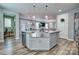 Stylish kitchen island with a stainless steel sink, granite countertops, and modern pendant lighting at 5050 Watersail Way, Lake Wylie, SC 29710