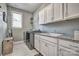 Functional laundry room with granite counters, sink, window and modern washer and dryer at 5050 Watersail Way, Lake Wylie, SC 29710