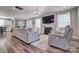 Bright living room featuring a fireplace, plush seating, and views of the outdoor landscape at 5050 Watersail Way, Lake Wylie, SC 29710