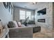 Upstairs loft space including a stacked stone fireplace and entertainment center at 5050 Watersail Way, Lake Wylie, SC 29710