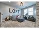Loft area featuring a comfortable gray sofa, exercise bike, and modern accents at 5050 Watersail Way, Lake Wylie, SC 29710
