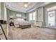Large main bedroom features a trey ceiling, a ceiling fan, and a sitting bench at 5050 Watersail Way, Lake Wylie, SC 29710