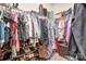Walk-in closet with hanging clothes and shoes on shelves at 5050 Watersail Way, Lake Wylie, SC 29710