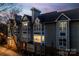 Exterior shot of condo building featuring brick and gray siding with multiple windows at dusk at 509 N Graham St # 2D, Charlotte, NC 28202