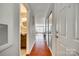 Hallway featuring wood floors leading to living area with bathroom and closet on the left at 509 N Graham St # 2D, Charlotte, NC 28202