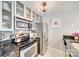 Stylish kitchen features stainless steel appliances and glass-front cabinets at 509 N Graham St # 2D, Charlotte, NC 28202
