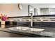 Close up of the kitchen sink, featuring modern faucet and granite countertops at 509 N Graham St # 2D, Charlotte, NC 28202