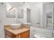 Bright bathroom features a vessel sink, granite countertop, and neutral color palette at 525 N Graham St # 3B, Charlotte, NC 28202