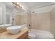 Bathroom with a vessel sink, large mirror, and tiled shower at 525 N Graham St # 3B, Charlotte, NC 28202