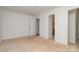 A bright bedroom with neutral carpet, a white door, and access to the bathroom at 525 N Graham St # 3B, Charlotte, NC 28202