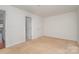 This empty bedroom features neutral carpet, light walls, and two closets at 525 N Graham St # 3B, Charlotte, NC 28202