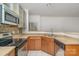 This kitchen features granite countertops, a tile backsplash, and stainless steel appliances at 525 N Graham St # 3B, Charlotte, NC 28202