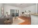 Bright living room features a sliding door to a balcony, table with seating, and wood flooring at 525 N Graham St # 3B, Charlotte, NC 28202