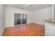 Living room with wood floors, neutral walls, recessed lighting, and sliding glass doors to the balcony at 525 N Graham St # 3B, Charlotte, NC 28202