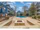 Charming pool area with a cozy fire pit and comfortable lounge seating for outdoor enjoyment at 525 N Graham St # 3B, Charlotte, NC 28202