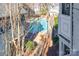 Aerial view of community pool surrounded by trees at 525 N Graham St # 3B, Charlotte, NC 28202