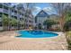 Well-maintained community pool featuring a brick patio and nearby clubhouse, offering a great amenity at 525 N Graham St # 3B, Charlotte, NC 28202