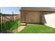 View of the backyard featuring a small lawn, a storage shed, and a fence, offering a private outdoor space at 5337 Orchid Bloom Dr, Indian Land, SC 29707