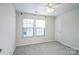 Cozy bedroom features plush carpeting, a ceiling fan, and natural light streaming through the windows at 5337 Orchid Bloom Dr, Indian Land, SC 29707