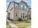 Charming two-story townhome with brick and siding, complemented by neat landscaping and a welcoming walkway at 5337 Orchid Bloom Dr, Indian Land, SC 29707