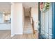 Welcoming foyer with beautiful wood floors, a staircase and a decorative wreath at 5337 Orchid Bloom Dr, Indian Land, SC 29707