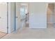 Hallway leading to staircase, bathed in natural light, creating an inviting and open atmosphere at 5337 Orchid Bloom Dr, Indian Land, SC 29707