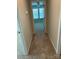 Hallway view into sunlit bedroom with plush carpeting, ceiling fan and bright windows at 5337 Orchid Bloom Dr, Indian Land, SC 29707