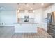 Modern kitchen features white cabinetry, granite countertops, and stainless appliances at 5337 Orchid Bloom Dr, Indian Land, SC 29707
