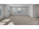 Spacious living room filled with natural light from multiple windows, creating a bright and airy space at 5337 Orchid Bloom Dr, Indian Land, SC 29707