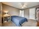 Bedroom featuring a blue bedspread, neutral walls, carpet, and a ceiling fan at 736 Meadow Lake Dr, Matthews, NC 28105