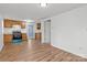 Inviting kitchenette features hardwood floors, wood cabinets, and new appliances, illuminated by overhead lighting at 7711 Carelock Cir, Charlotte, NC 28215