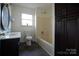Updated bathroom with vanity, bathtub, and modern finishes at 8405 Fairview Rd, Mint Hill, NC 28227
