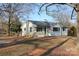 Welcoming single-story home with a ramp, covered porch, and well-maintained lawn at 8405 Fairview Rd, Mint Hill, NC 28227