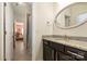 Hall bathroom featuring dark cabinets, granite countertop and a large oval mirror at 865 Kathy Dianne Dr, Fort Mill, SC 29707