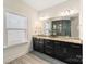 Bathroom with a vanity with double sinks, granite countertops, and a large mirror at 865 Kathy Dianne Dr, Fort Mill, SC 29707