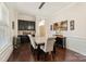 Elegant dining room with hardwood floors, featuring a stylish light fixture and a built-in bar area at 865 Kathy Dianne Dr, Fort Mill, SC 29707