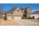 Charming brick and stone home with a three-car garage, perfect for a growing Gathering at 865 Kathy Dianne Dr, Fort Mill, SC 29707