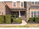 Inviting front porch with hanging plants and meticulous landscaping, leading to a stylish front door with wreath at 865 Kathy Dianne Dr, Fort Mill, SC 29707