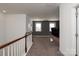 Hallway with neutral carpet leading to a media room with a gray accent wall at 865 Kathy Dianne Dr, Fort Mill, SC 29707