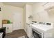Well-equipped laundry room with modern washer, dryer, and ample shelving for storage at 865 Kathy Dianne Dr, Fort Mill, SC 29707