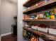 Well-organized pantry featuring rustic wood shelves and ample storage for food and household items at 865 Kathy Dianne Dr, Fort Mill, SC 29707