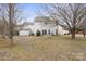 Spacious backyard featuring a large lawn, mature trees, and a storage shed at 9413 Pastern Ct, Charlotte, NC 28216
