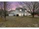 Backyard featuring a well-maintained lawn, mature trees and an outbuilding at 9413 Pastern Ct, Charlotte, NC 28216