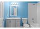 Updated bathroom featuring bright blue walls, white vanity, and a shower-tub combination at 9413 Pastern Ct, Charlotte, NC 28216