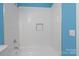 Bathroom features a white subway tile shower-tub combination and blue accent walls at 9413 Pastern Ct, Charlotte, NC 28216