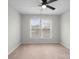 This room features neutral carpeting, fan, and lots of natural light from the double windows at 9413 Pastern Ct, Charlotte, NC 28216